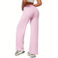 Pink high-waist wide-leg flared yoga pants back three quarter view on a model in studio
