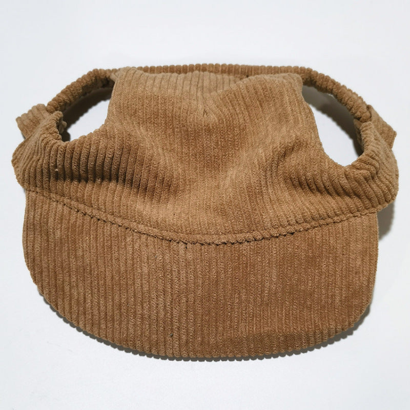 Yellow corduroy pet baseball cap on a corgi with the brim shading the eyes