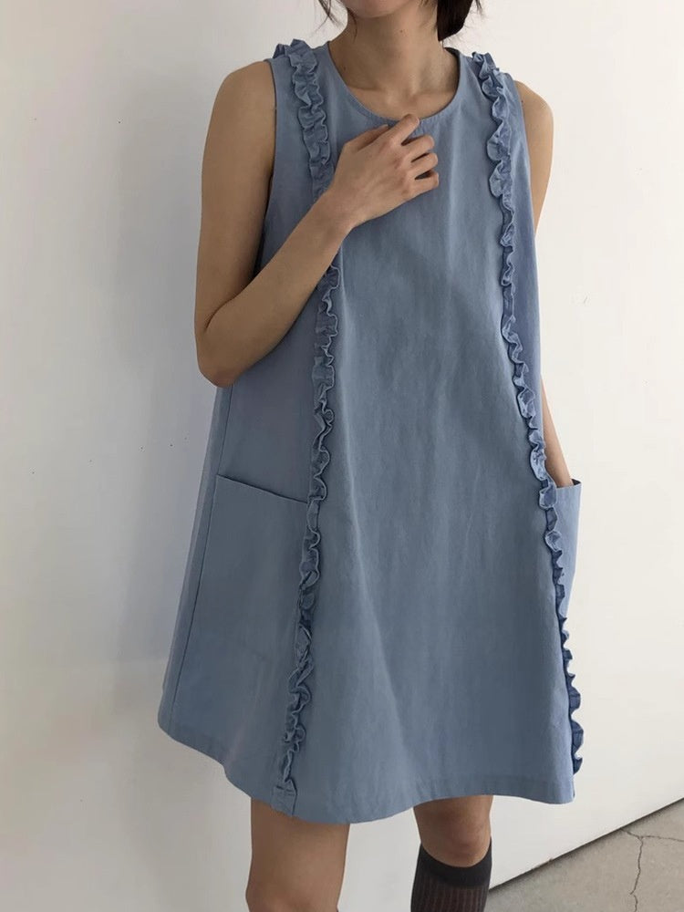 Soft blue sleeveless A-line dress with ruffle trims and front patch pockets, front view