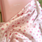 Rose story silk pillowcase with small pink roses beside a pink gift box