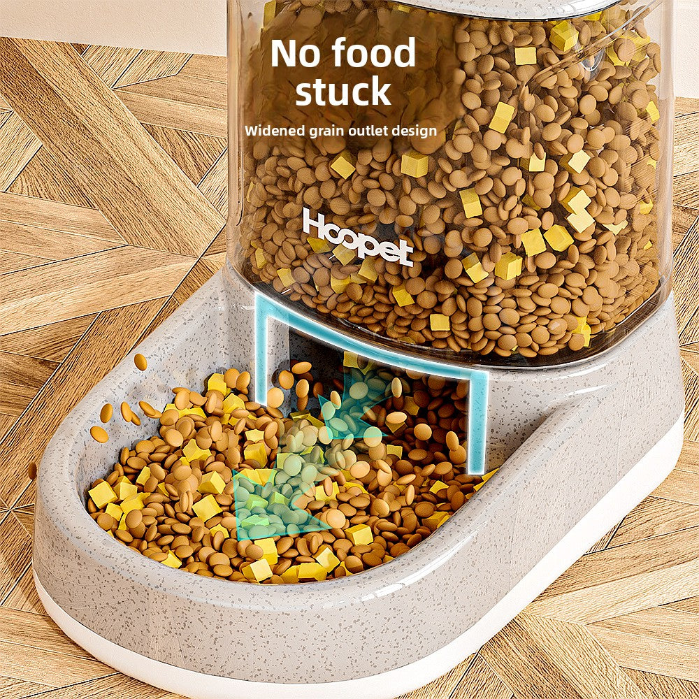 Close view of the food feeder outlet with kibble sliding into the bowl