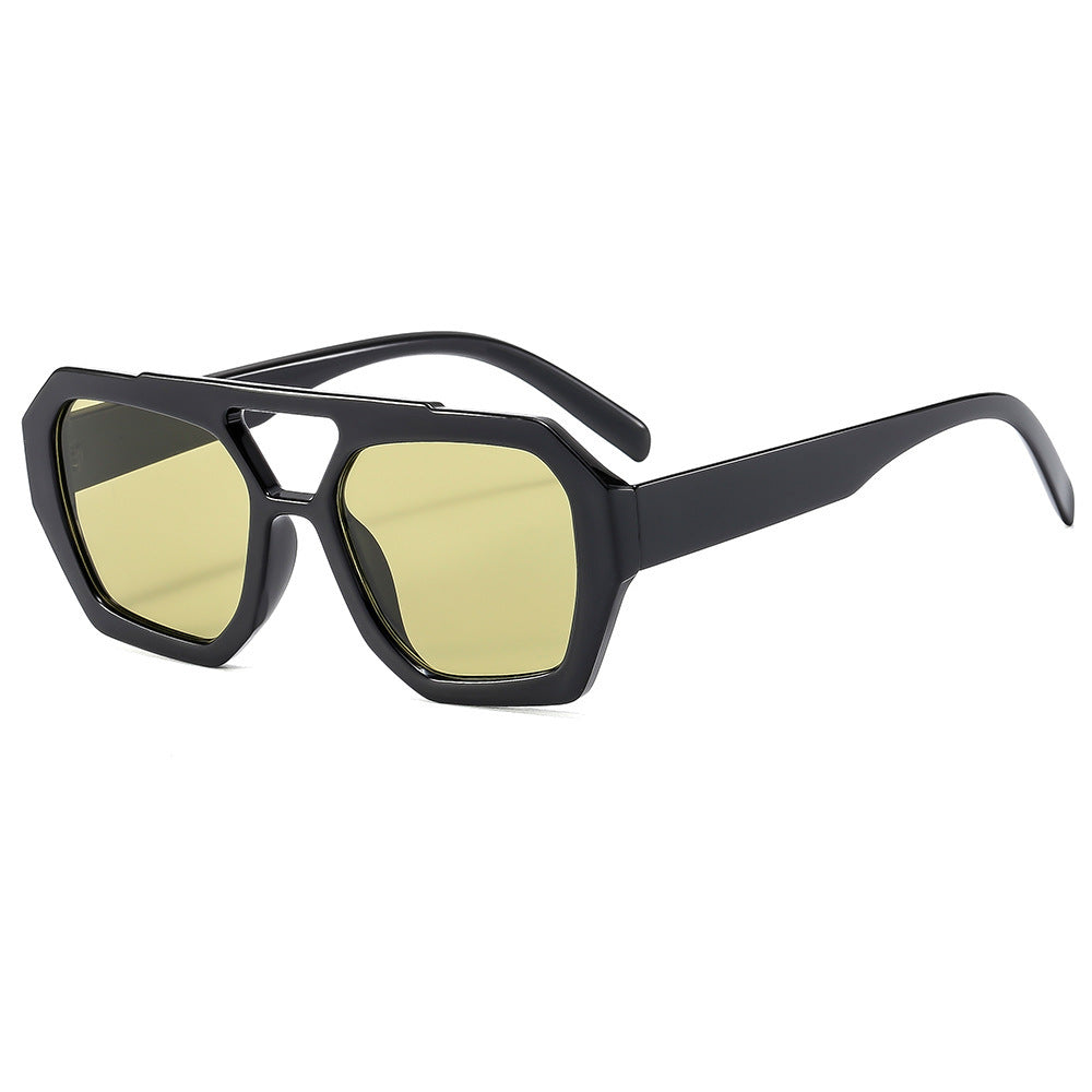 Retro polygonal sunglasses styled on a clean neutral surface