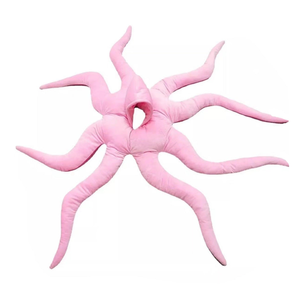 Pink octopus plush costume laid flat showing the hood opening and eight legs