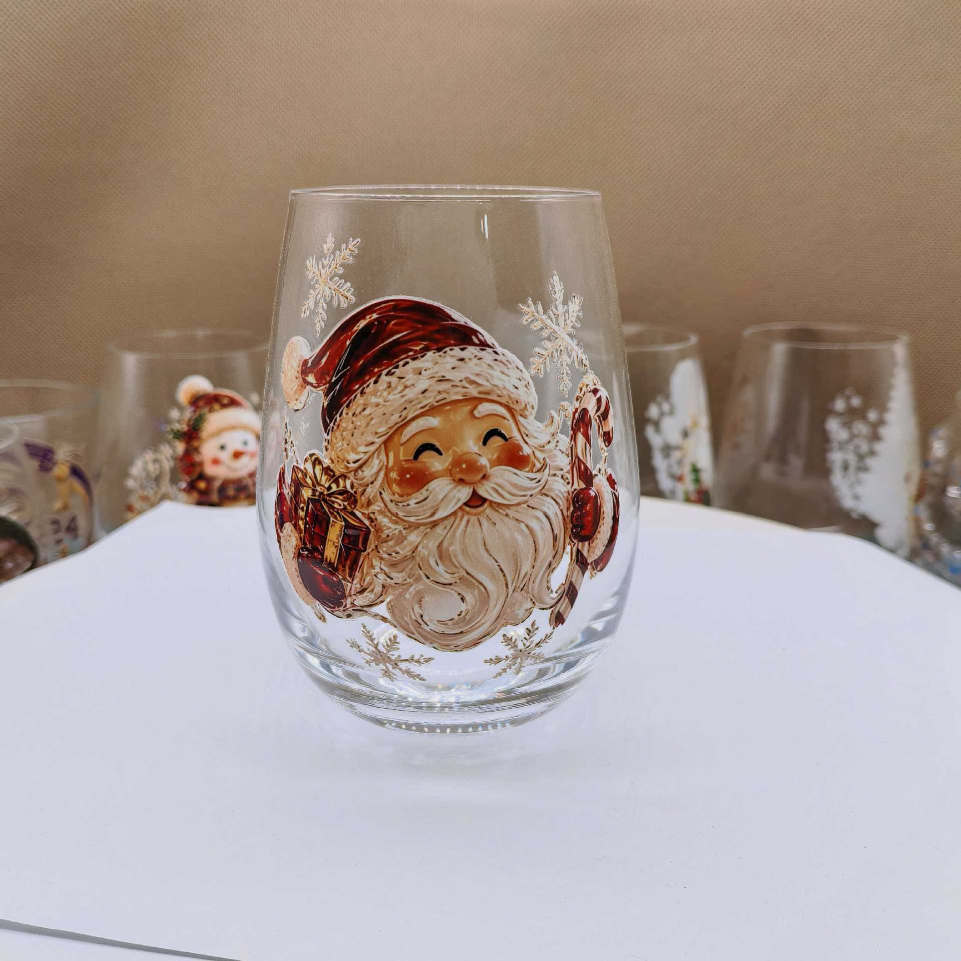 Clear borosilicate Christmas glass cup with a raised painted flat Santa holiday motif
