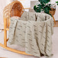 Pure cotton muslin swaddle blanket rolled up, showing the airy gauze texture and printed design