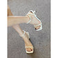 Foot wearing an off-white square toe ankle strap sandal with thin heel on a gray woven mat