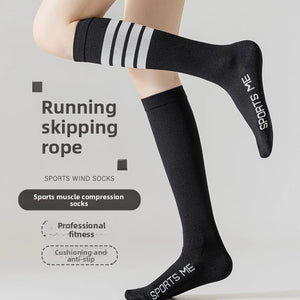Model wearing black long tube compression socks with white stripes for running and skipping rope