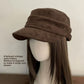 Vegan suede flat top cap in dark brown shown on a mannequin head