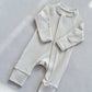 Lime White zip front baby romper laid flat on a gray floor, image of the 73 cm, 6 to 12 months size option