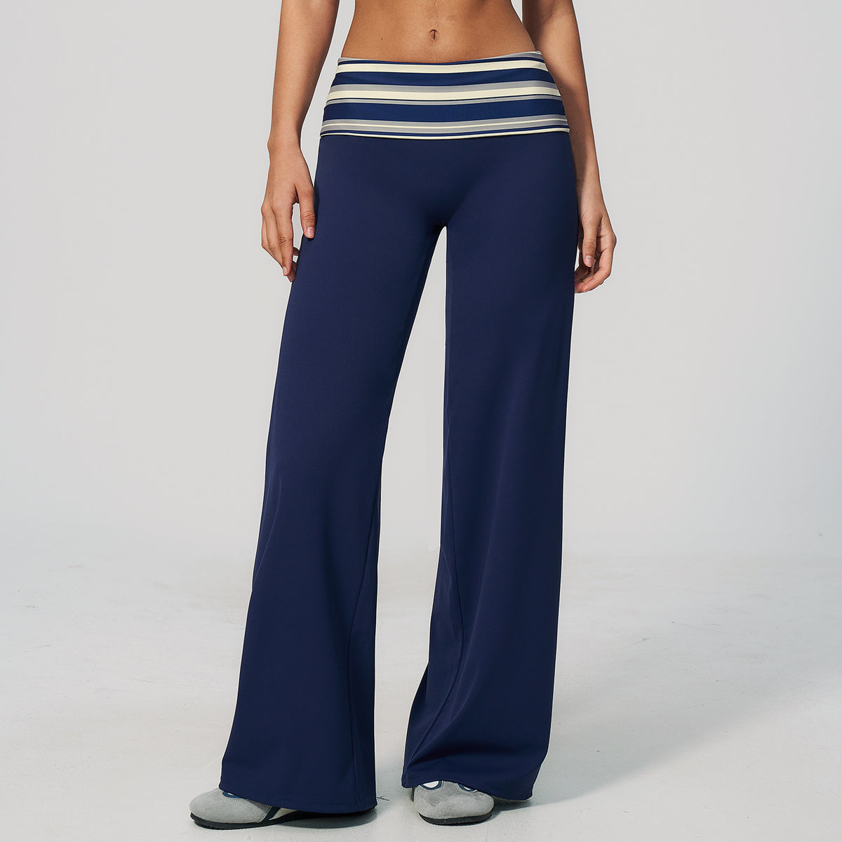 Model in wide leg pants with a fold over printed waistband, navy with cream and gray stripes