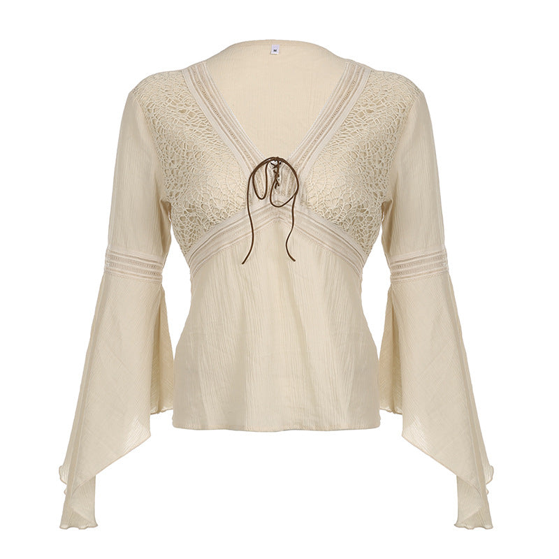 Front flat view of the cream blouse, ladder tapes tracing the empire seam and the elbow of each sleeve
