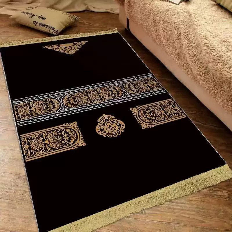 Plush velvet Islamic prayer mat with a printed ornamental design and fringed ends on a wood floor