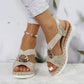 Gold beige wedge sandal with silver ring and peep toe, paired with white ripped jeans