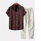 Brown short sleeve button shirt on a hanger with cream drawstring trousers, gallery style outside the 14 options