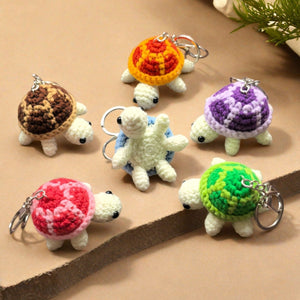Crochet turtle keychains arranged in a circle showing all six shell colours