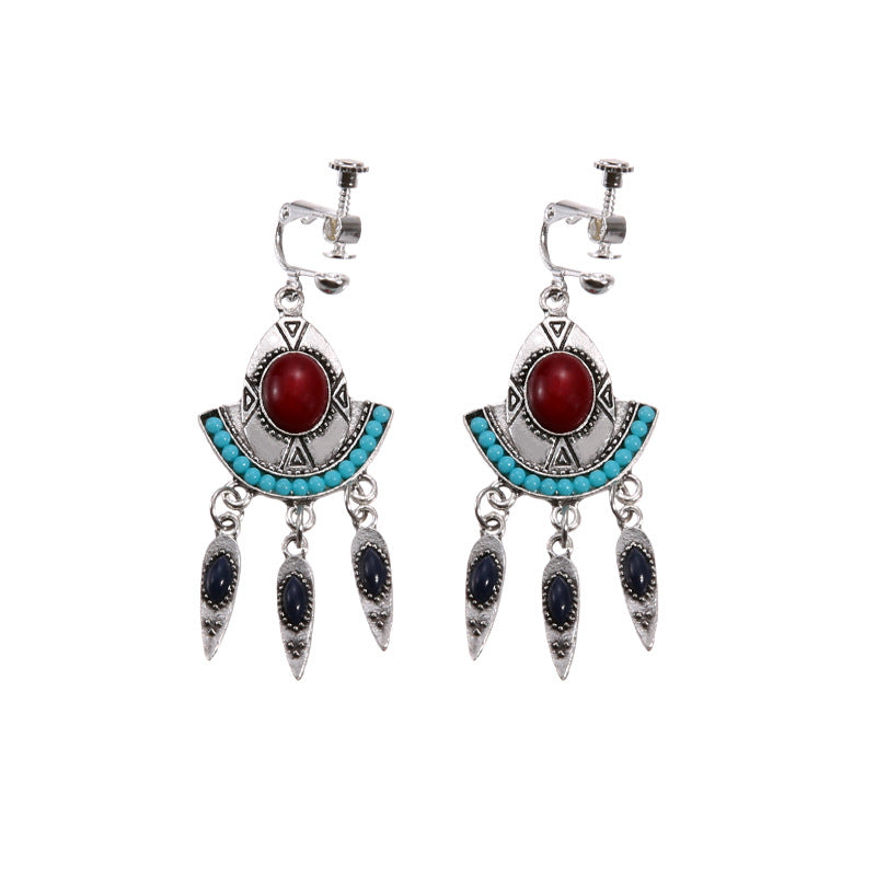 Bohemian vintage clip-on tassel drop earrings on a zinc alloy frame, handmade boho pair on white studio background