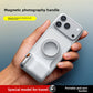 Magnetic phone photography grip held in one hand on the back of a phone