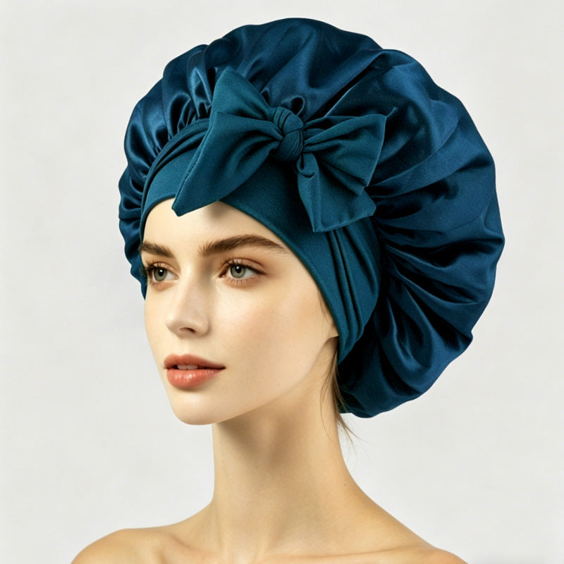 Large satin hair bonnet shown with the elastic band and two satin ties for the fit