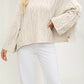 Soft thick knit round neck sweater with a twist cable pattern across the front