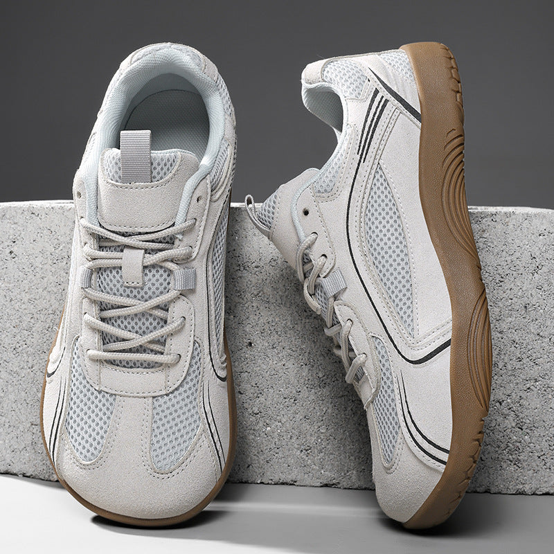 Light gray mesh lace-up sneakers with a gum brown flat sole on a concrete block, size 41 option photo