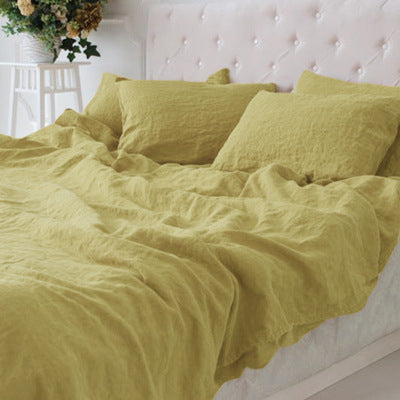 Cotton and linen blend bedding with a relaxed washed texture, shown in a modern bedroom