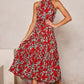 Red floral halter neck sleeveless tiered swing maxi dress worn by a model