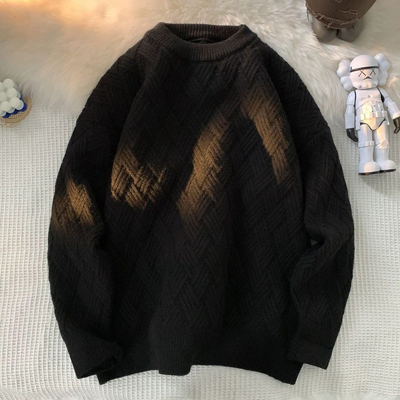 Black heavyweight round neck knit pullover with a raised basketweave jacquard texture
