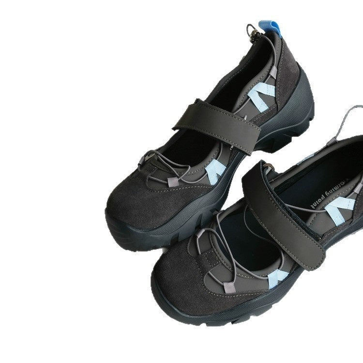 Pair of gray brown platform shoes with a wide strap and light blue accents on a white background