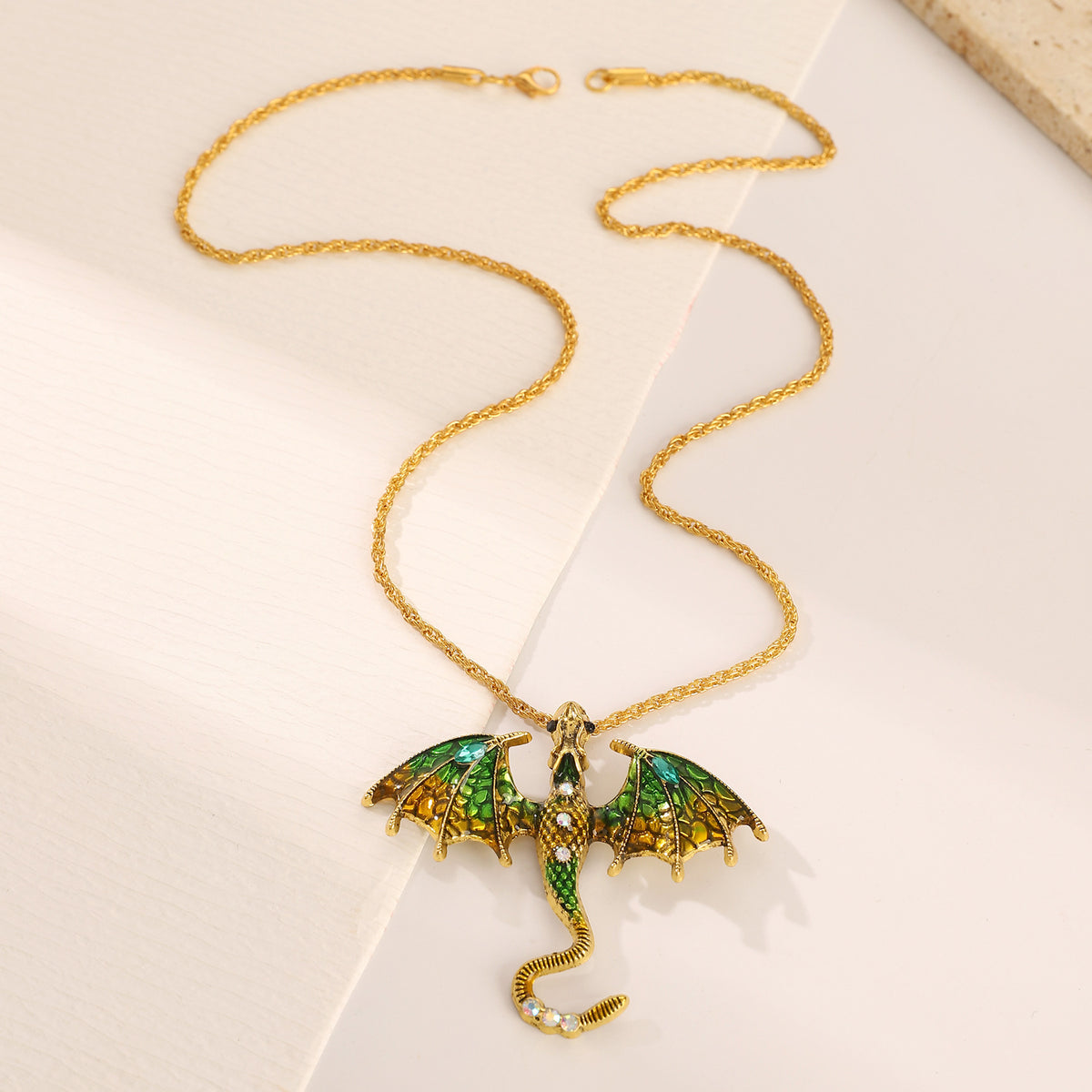 Close up of the dragon charm scales and enamel accent in antiqued metal