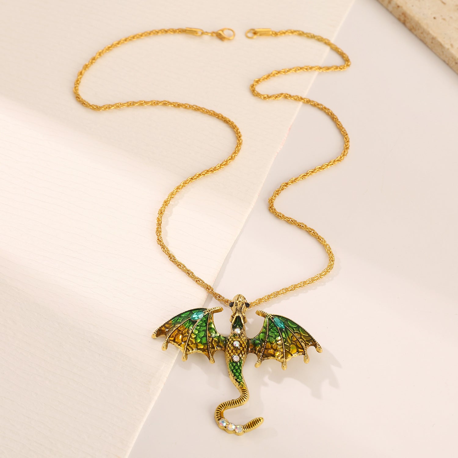 Close up of the dragon charm scales and enamel accent in antiqued metal
