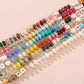 Close detail of natural stone rondelle beads, freshwater pearl and glass daisy on the handmade necklace