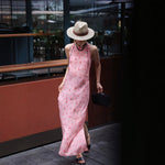 Pink cherry gingham silk halter maxi dress worn walking with a straw hat