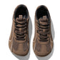 Pair of brown mesh sneakers with a roomy round toe box and brown laces, seen from above on white