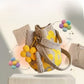 Yellow floral crochet cotton bucket bag with a detachable flower and tassel charm