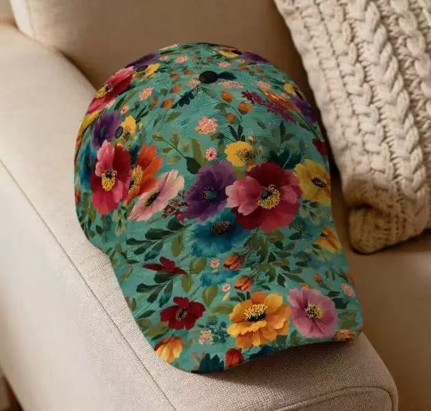 Front view of a floral print cap with a bright bloom pattern on a cream base