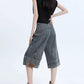 Denim shorts styled with a tucked tee, angled view