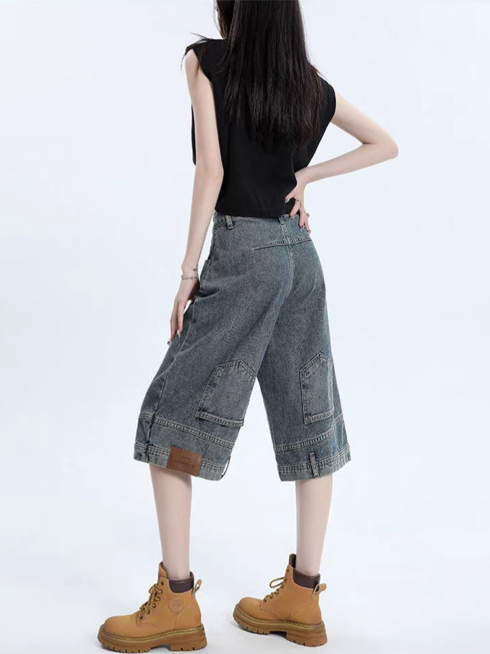 Denim shorts styled with a tucked tee, angled view