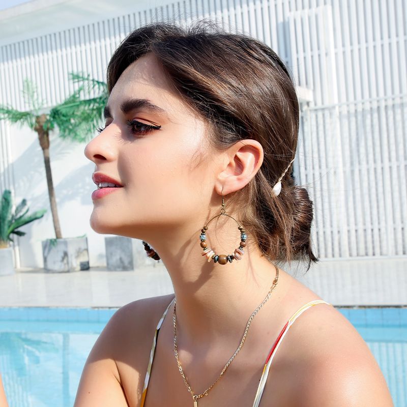 Boho vintage clip-on drop earrings with fringe and bead accents, zinc alloy build, studio image on white background
