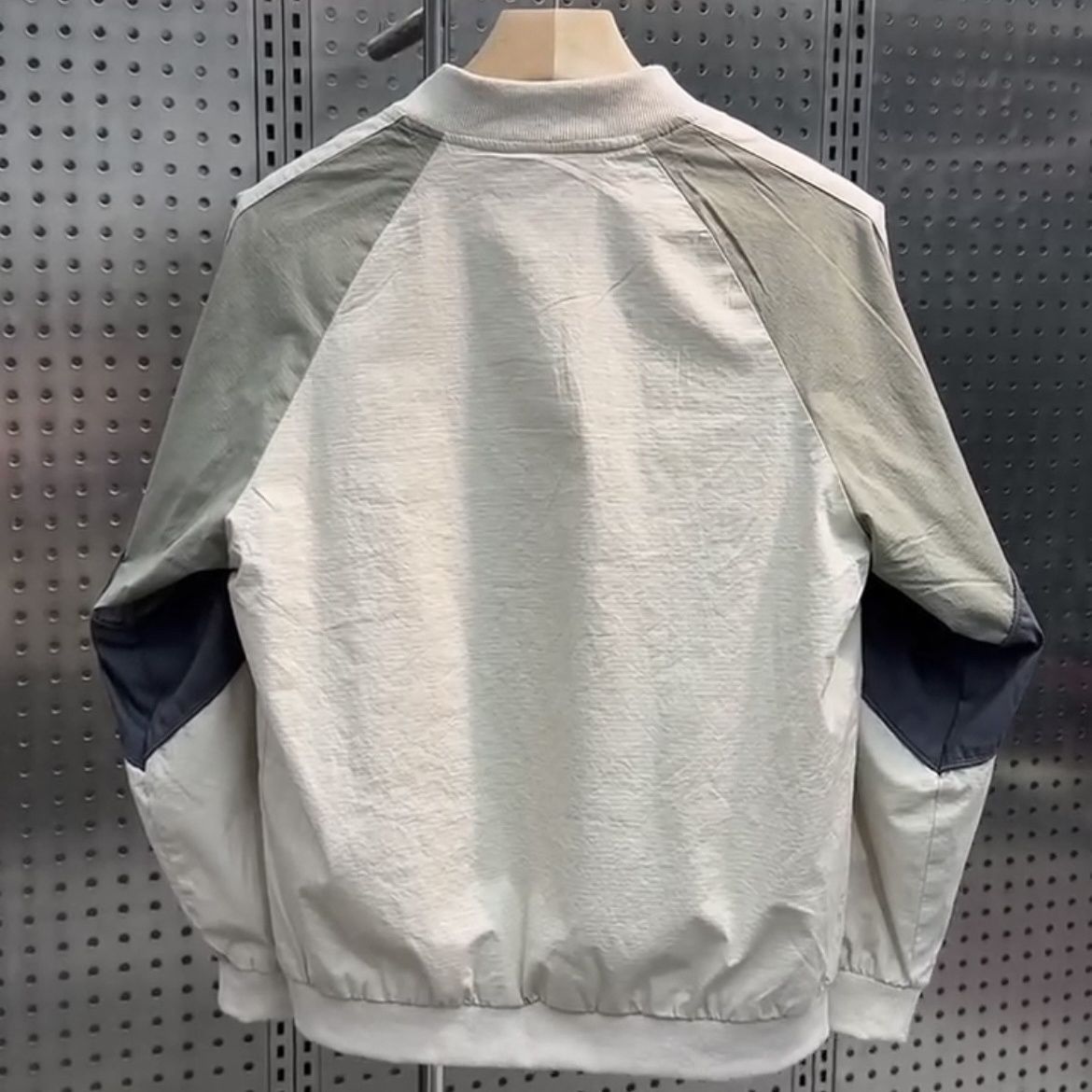 Thin baseball collar jacket worn open over a plain tee for a relaxed look