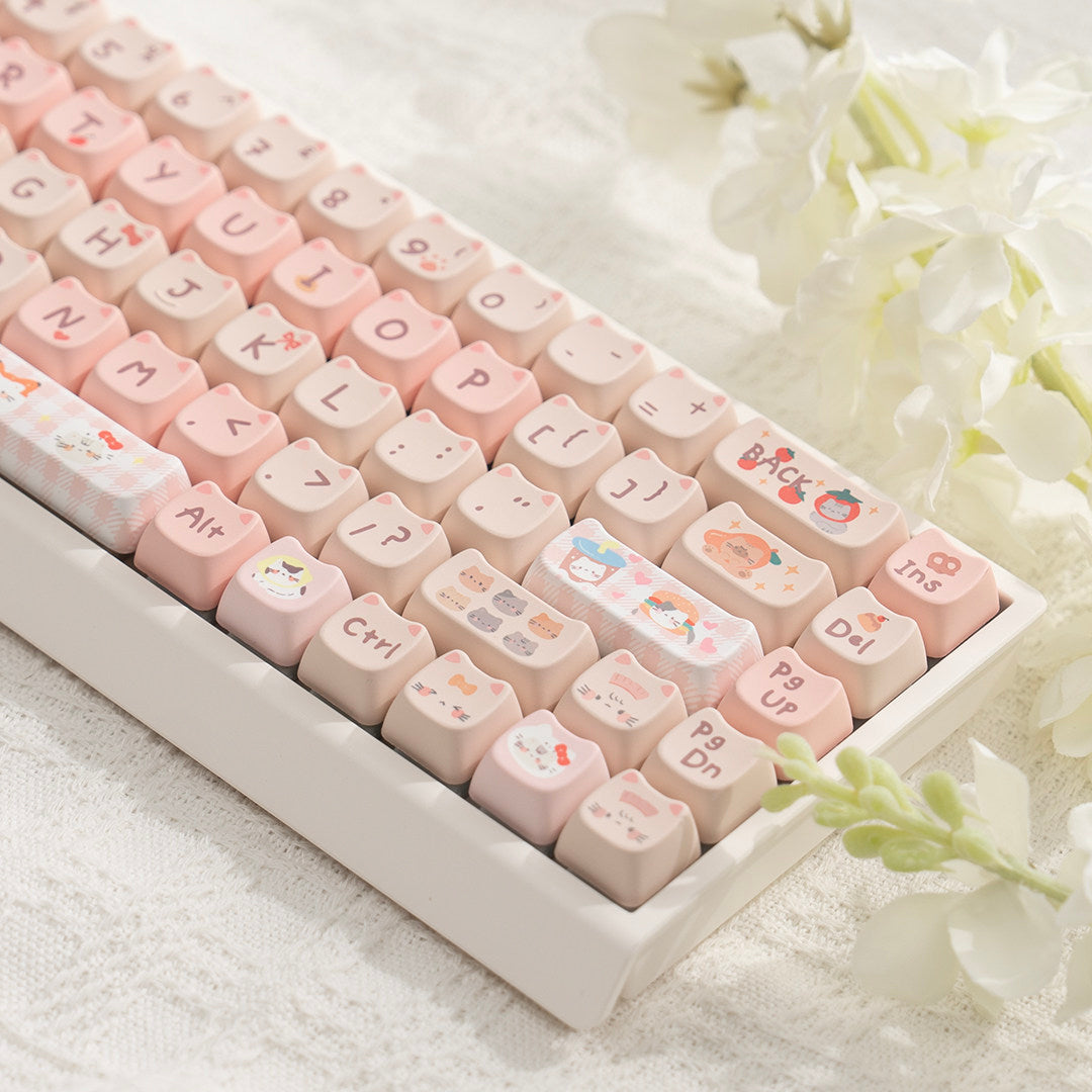 Pastel cat themed 68 key mechanical keyboard resting on a soft woven cloth