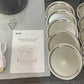 Mason jar of coffee beans kept fresh beside the compact electric vacuum sealer