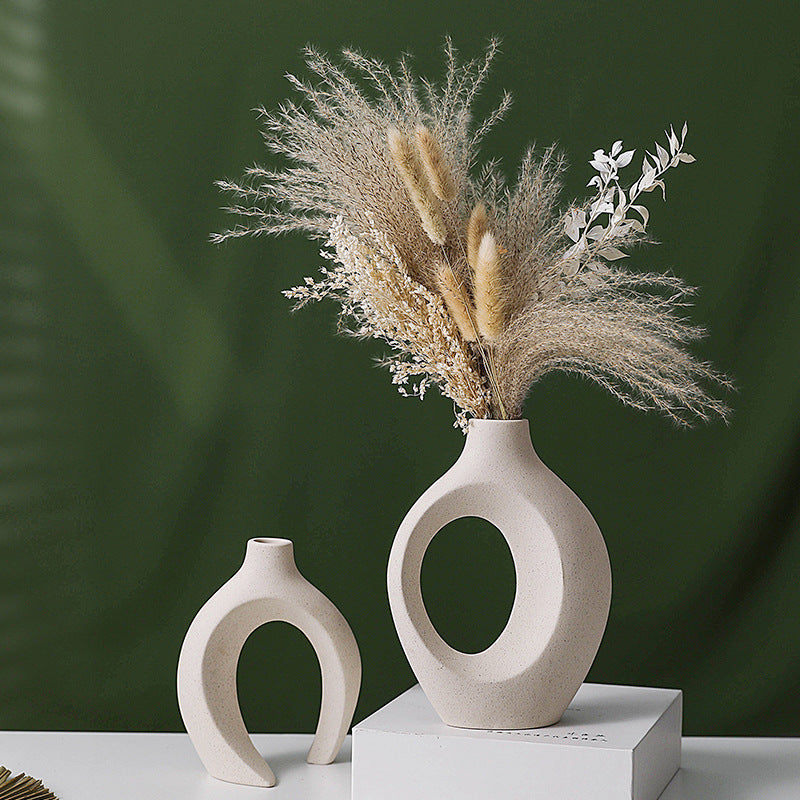 Nesting ceramic vase pair on a table with dried pampas grass