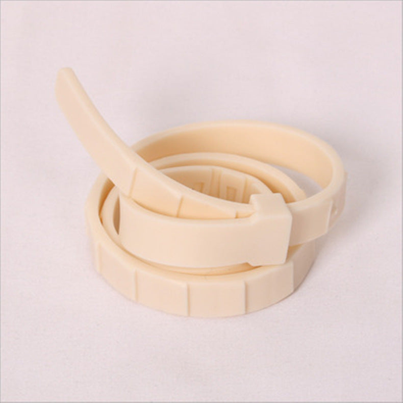 Black adjustable pet collar band coiled inside its round tin box