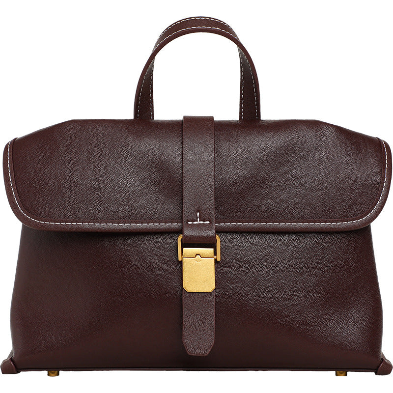 Coffee brown flap satchel with a top handle and a gold-tone buckle lock on a white background, front view