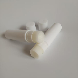 SliceFix golf anti slice white wax stick standing upright on plain background