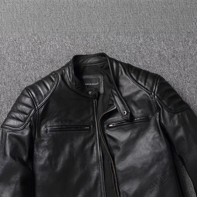 Close-up of a black jacket stand collar with a snap tab, quilted shoulder and a slanted chest zip pocket