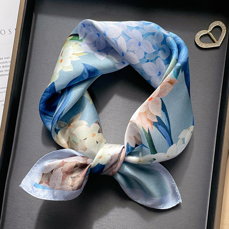 Blue watercolor floral printed square scarf with a satin sheen and hemmed edges, shown displayed