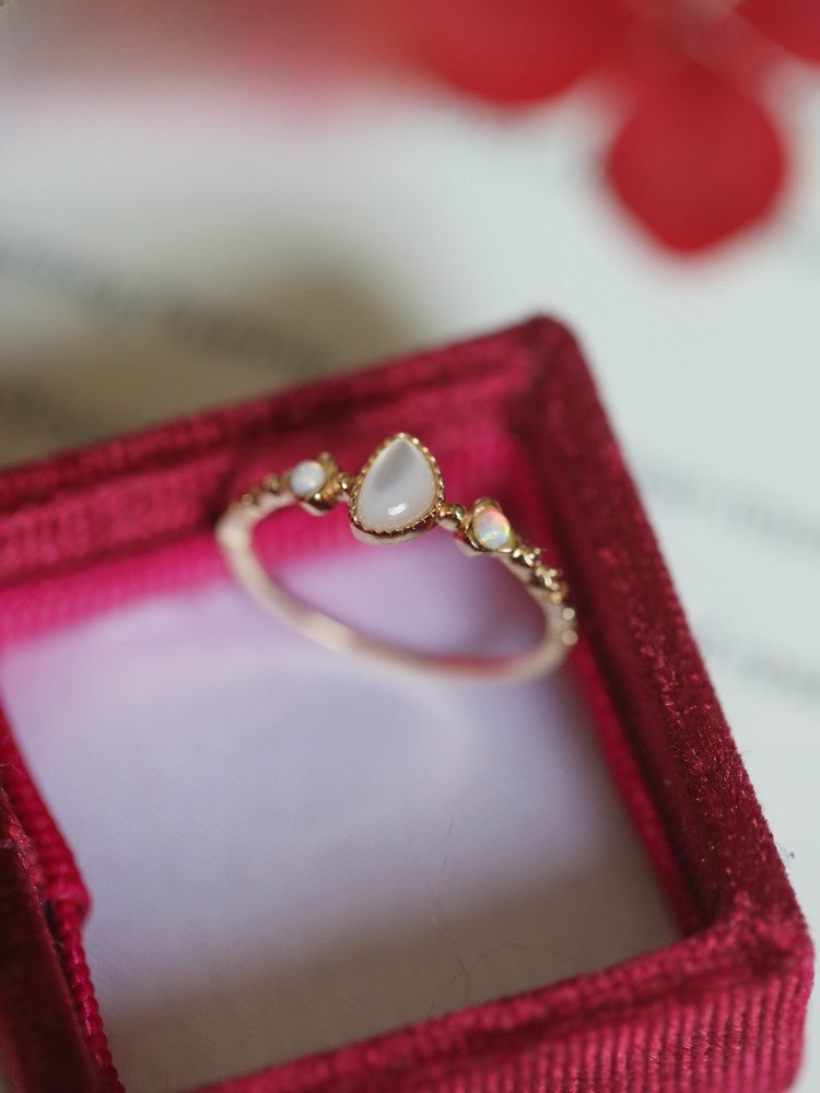 Side view of the adjustable open band with teardrop cabochon in a red velvet box