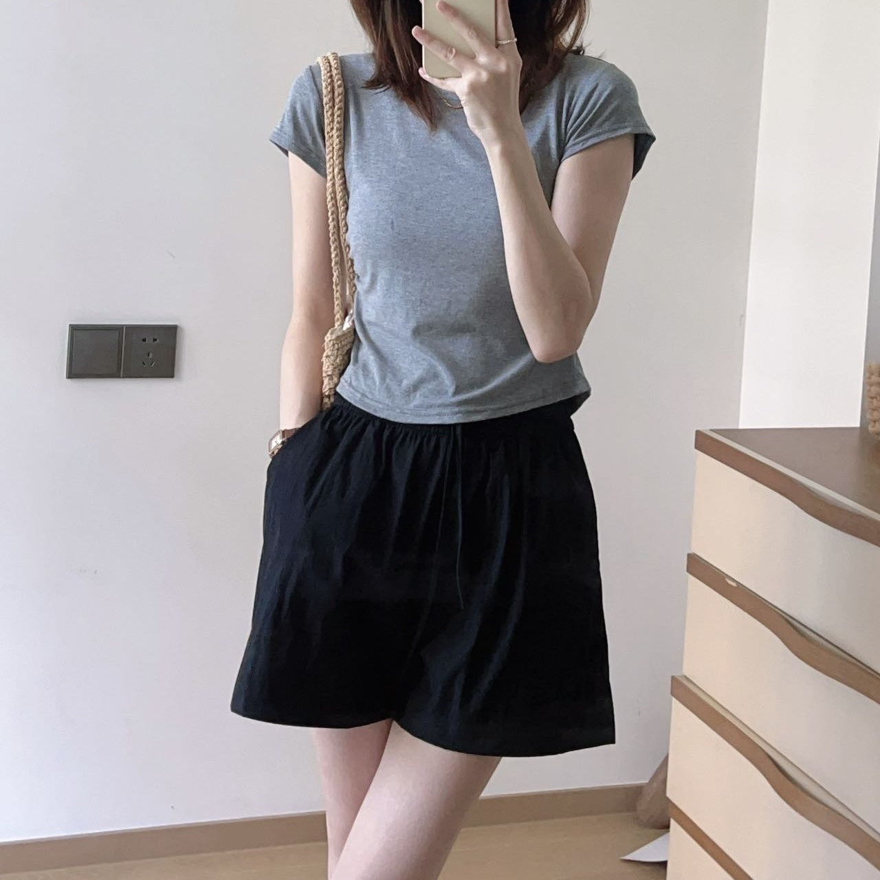 Woman wearing wide leg ice silk shorts showing the thin smooth synthetic fabric