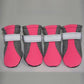 Mesh dog shoe held to show the soft flexible rubber sole and grip tread